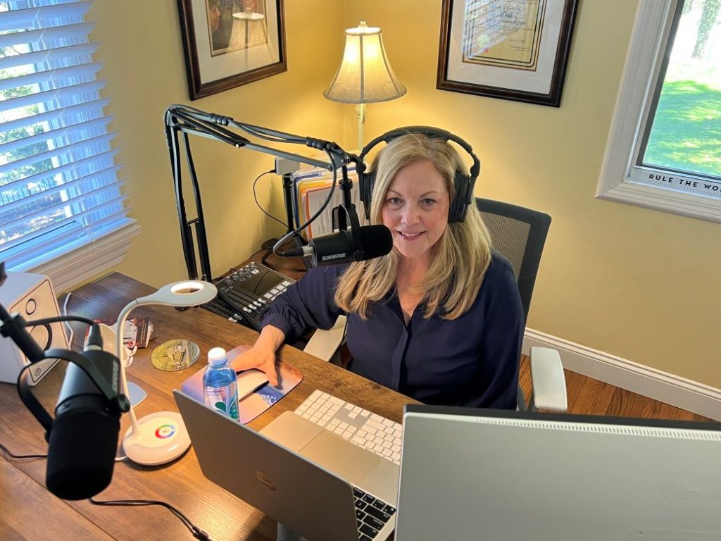Photo of Joan Cergol at her podcast desk