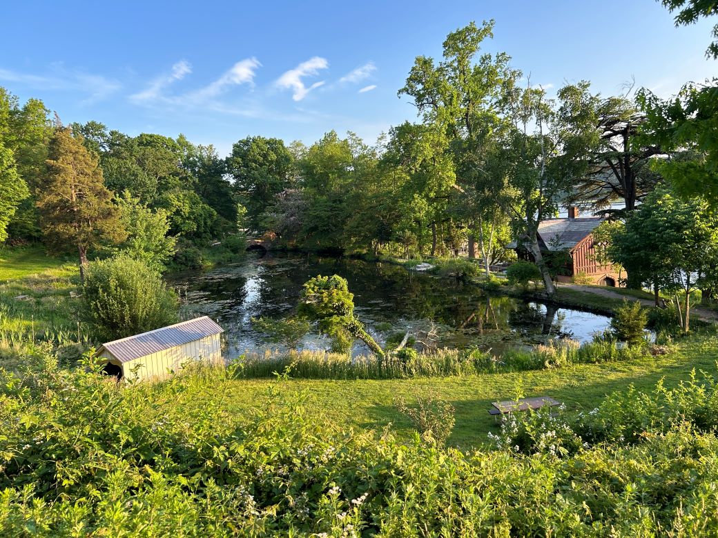 Photo of the pond at Cedarmere Preserve with the old Mill House in the background