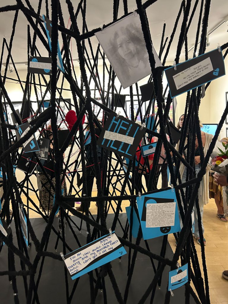 an image depicting the web installed at the Huntington Arts Council, embedded with images, diary excerpts and an entangled heart.